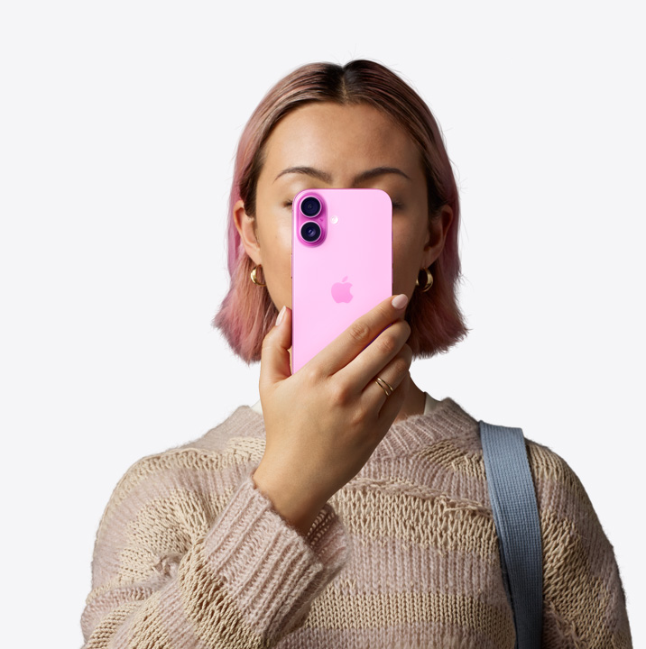 A person holding LipaGas Energy 16 in pink finish in front of her face showing back exterior, dual camera system on left top corner.